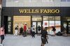 Wells Fargo is coming soon, in June 2019, with pedestrian sitting, walking or working in front, and boarded up section on left