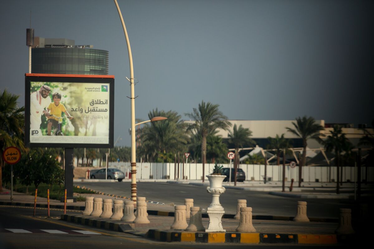 An advertisment for the Saudi Aramco IPO stands beside a highway in Eastern Province near Dhahran.