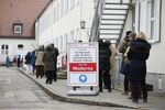Visitors wait to receive Covid-19 vaccines at a vaccine center in Munich, Germany, on Dec. 2.