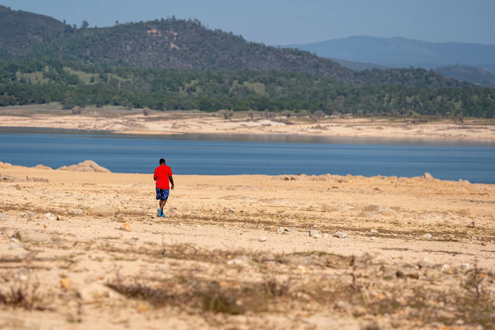 A person walks on a dried lake bed at Folsom Lake&nbsp;reservoir in Folsom, California, on&nbsp;March 31.&nbsp;