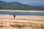 A person walks on a dried lake bed at Folsom Lake&nbsp;reservoir in Folsom, California, on&nbsp;March 31.&nbsp;