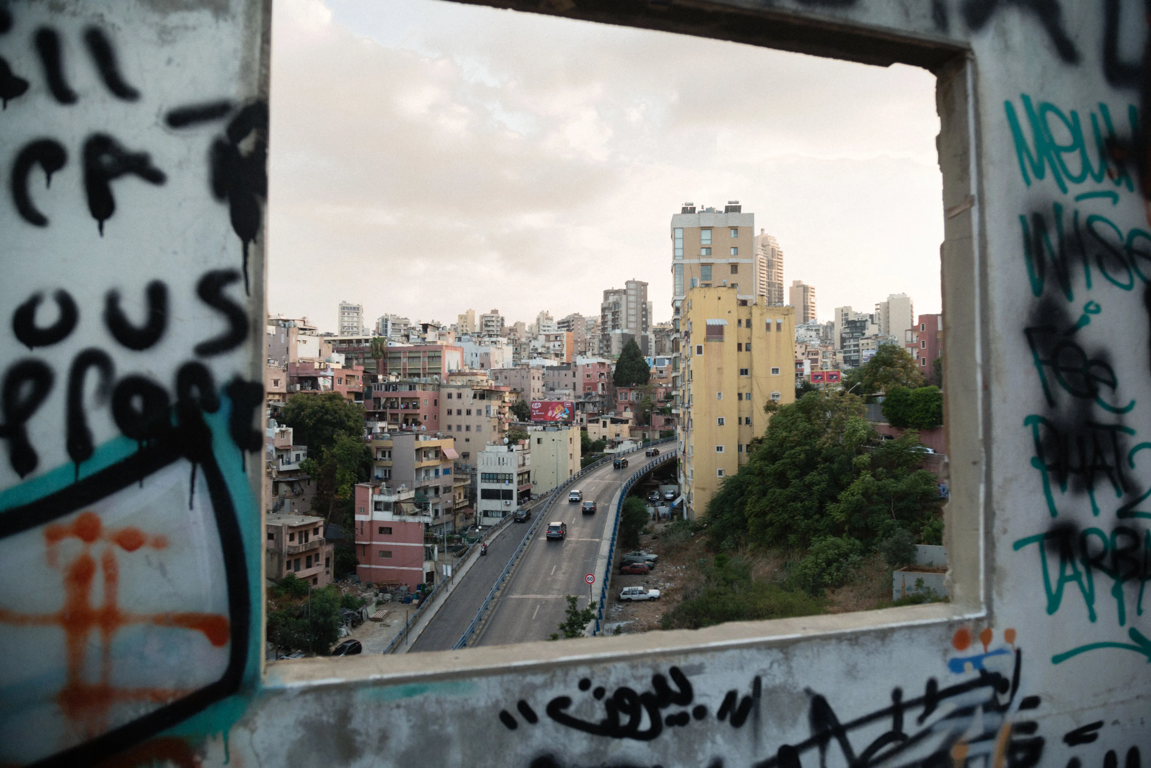Tower blocks line a highway seen through the window of an abandoned building in Beirut, Lebanon.&nbsp;