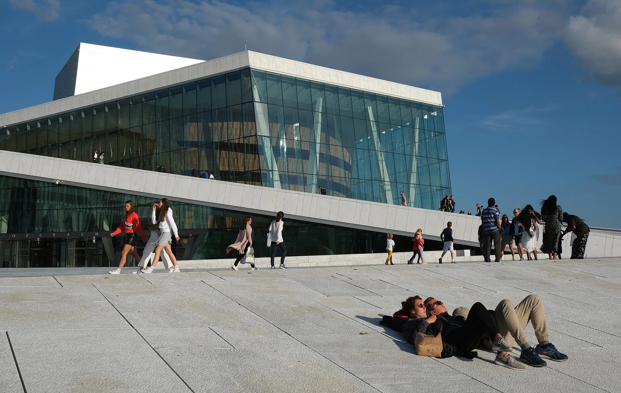 People relax outside the Oslo Opera House&nbsp;on July 27.