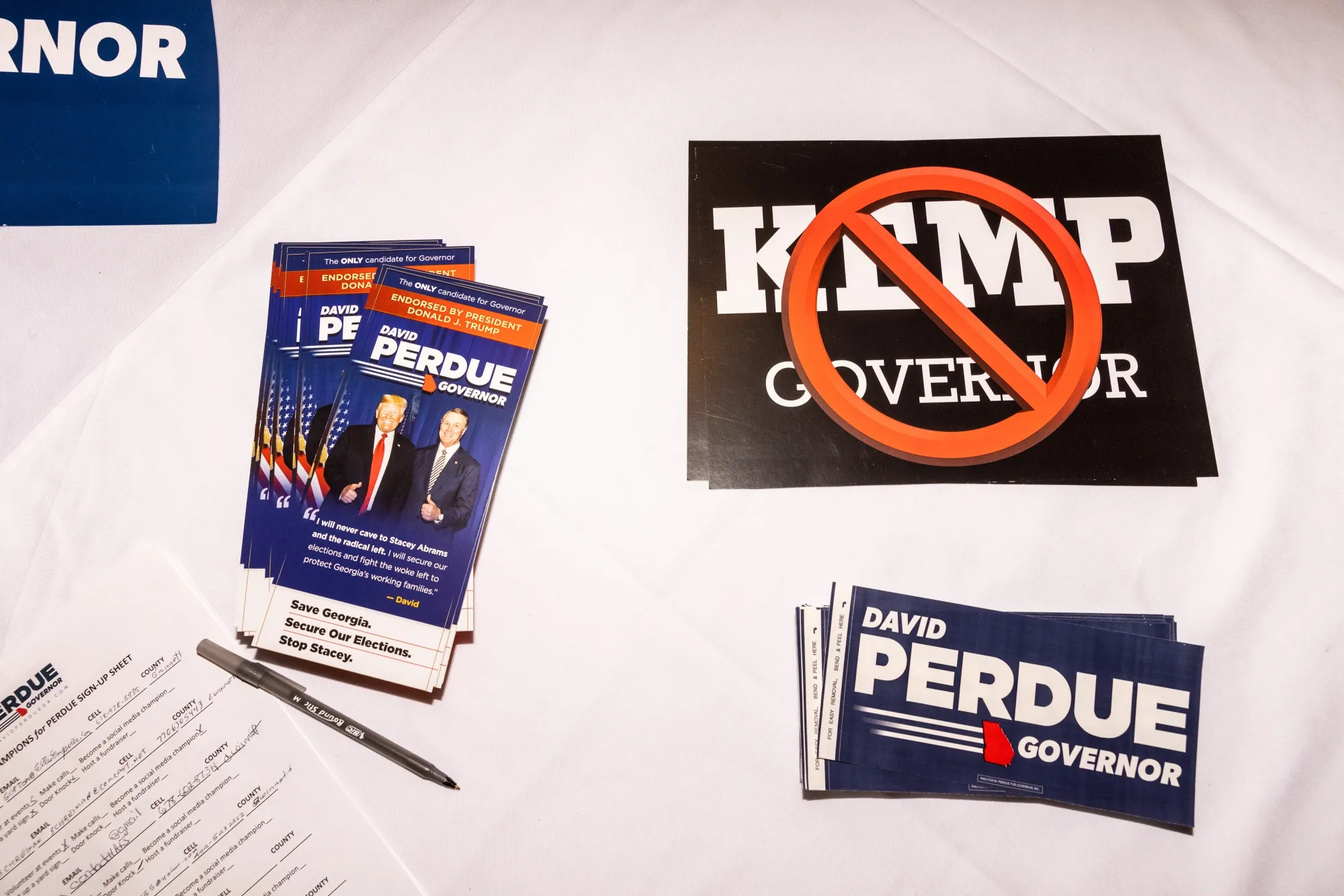 Signs against Republican Georgia Governor Brian Kemp for attendees to take during a campaign event for David Perdue, Republican gubernatorial candidate for Georgia, in Duluth, Georgia.