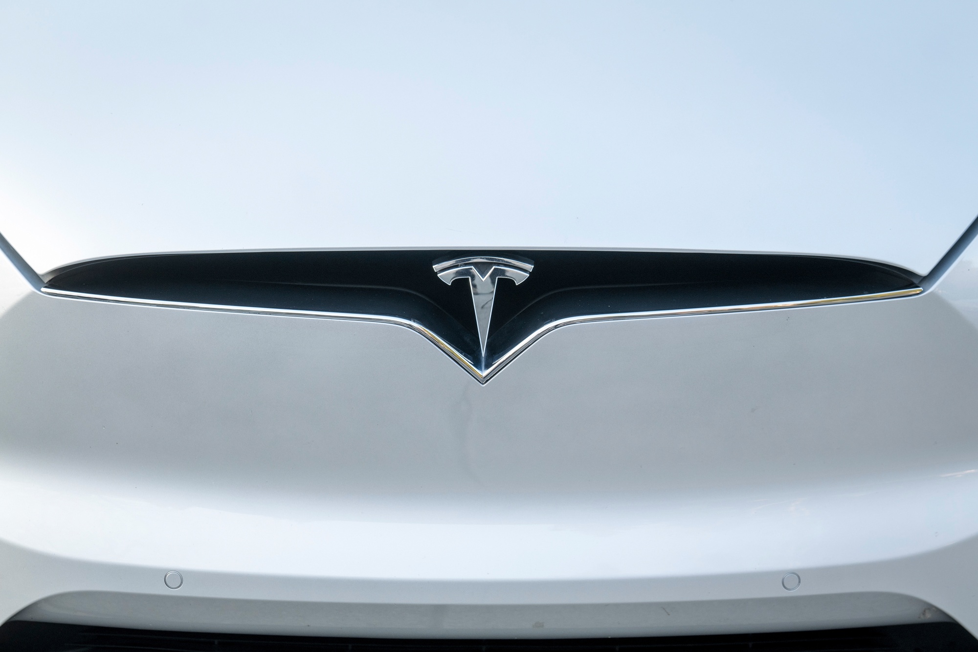 A Tesla Inc. badge is displayed on a Model X electric vehicle in San Ramon, California.