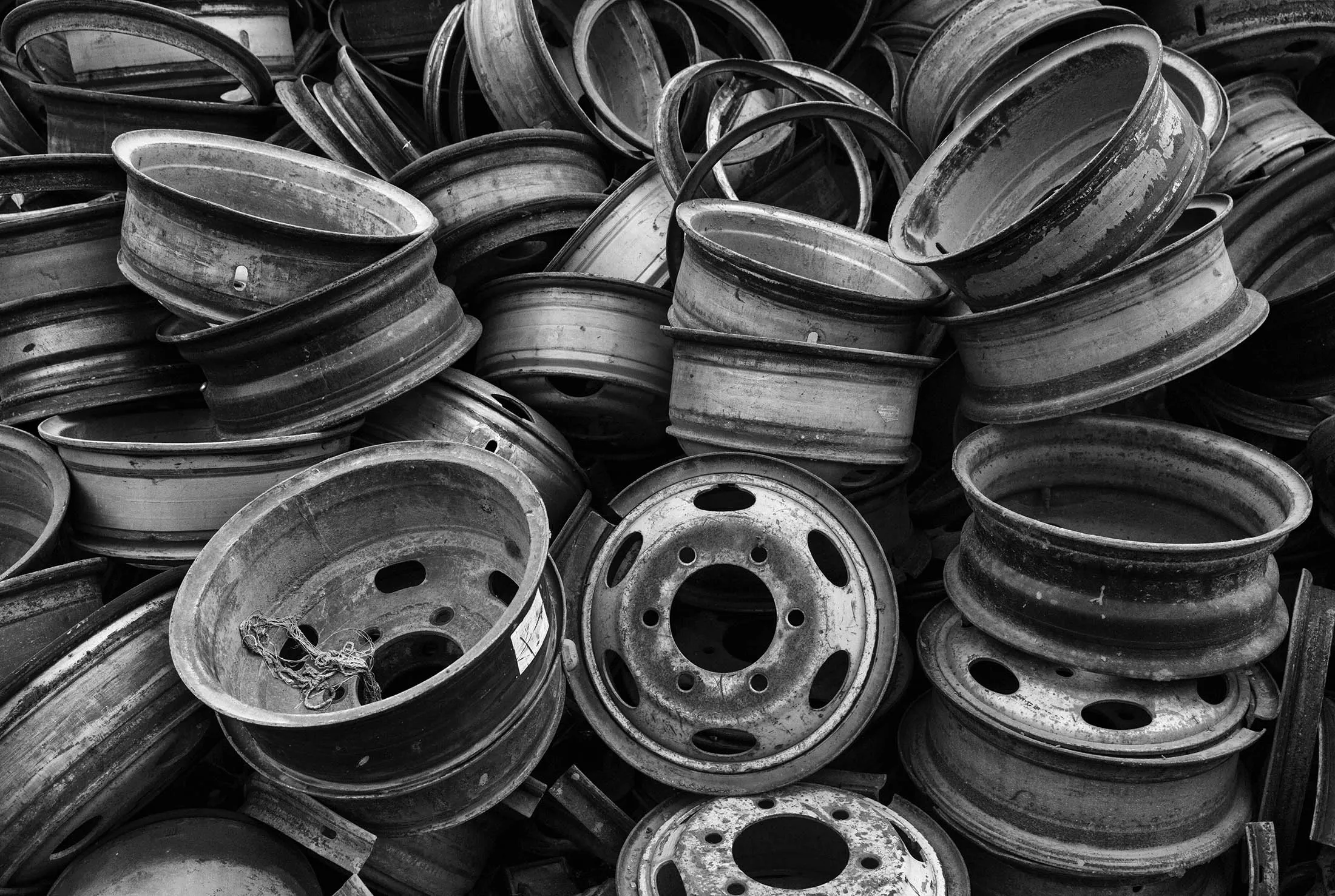 Wheel rims from high polluting vehicles taken off the road by authorities are seen piled up at an auto scrapyard in Zhejiang, China.
