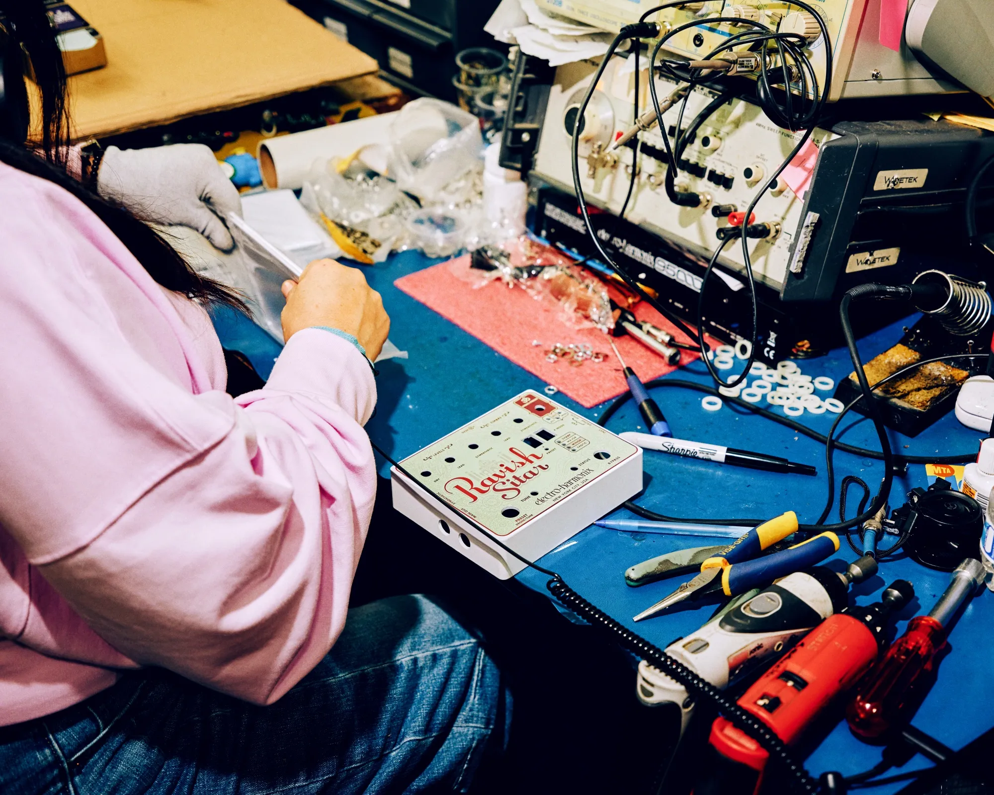 A worker assembles a guitar pedal at the Electro-Harmonix manufacturing facility in New York on March 6.
