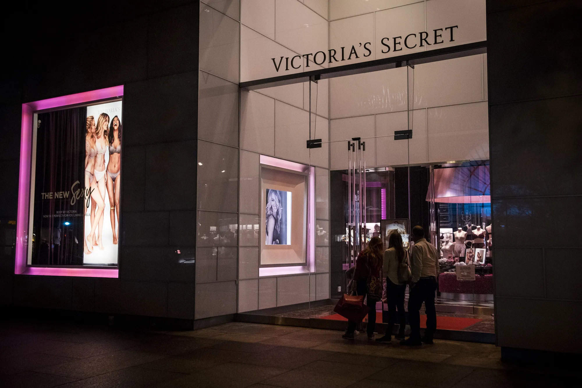 Pedestrians look inside a Victoria's Secret store&nbsp;in Chicago.