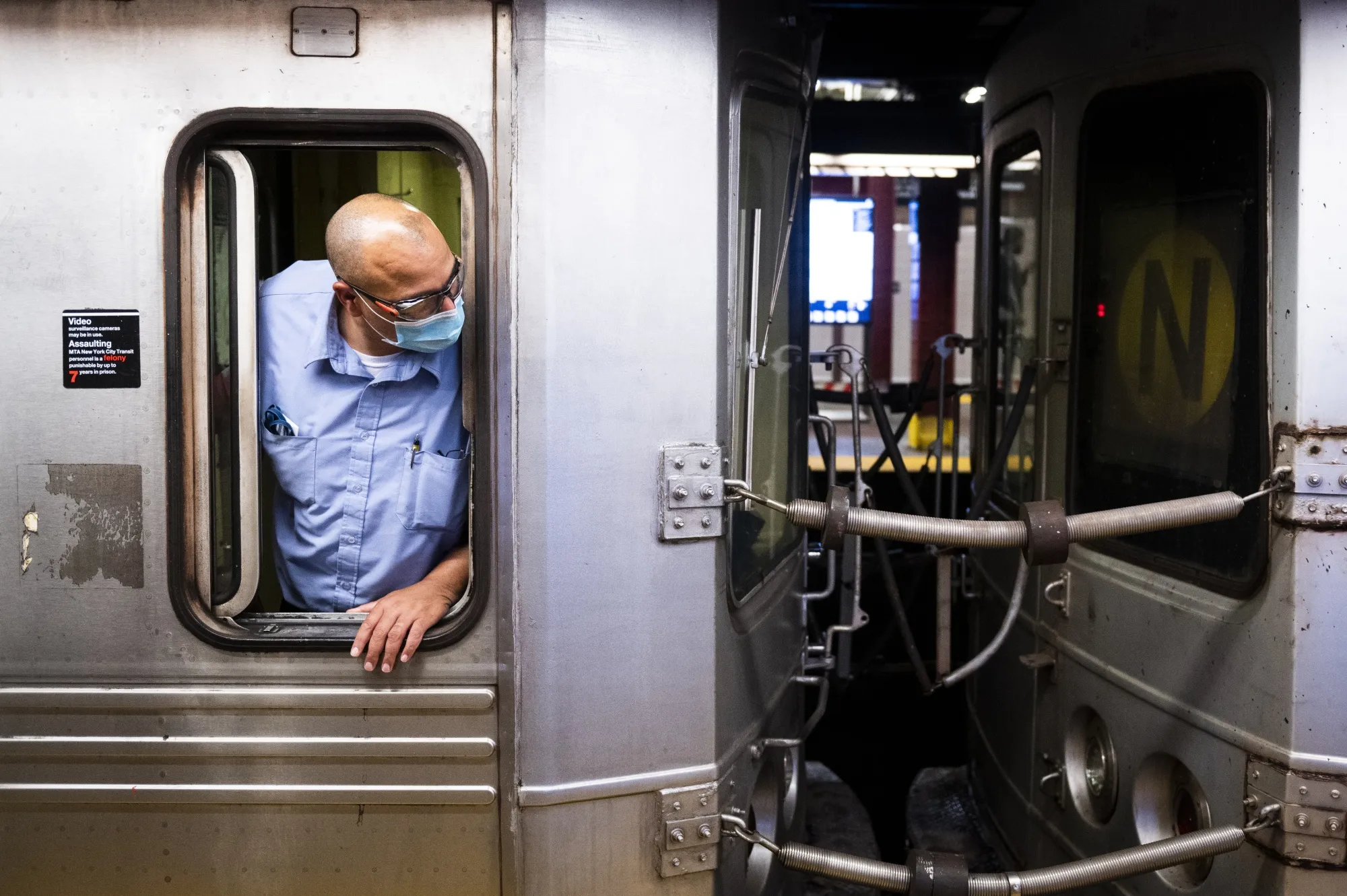 A conductor checks for commuters at a subway station in New York.&nbsp;