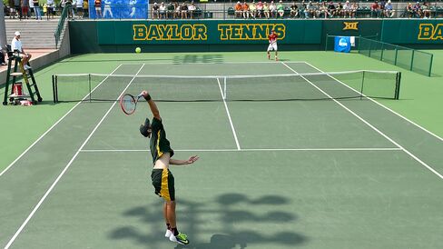 Baylor's Julian Lenz serves to USC's Yannick Hanfmann during an NCAA men's team quarterfinal on May 16, 2015, in Waco, Tex.