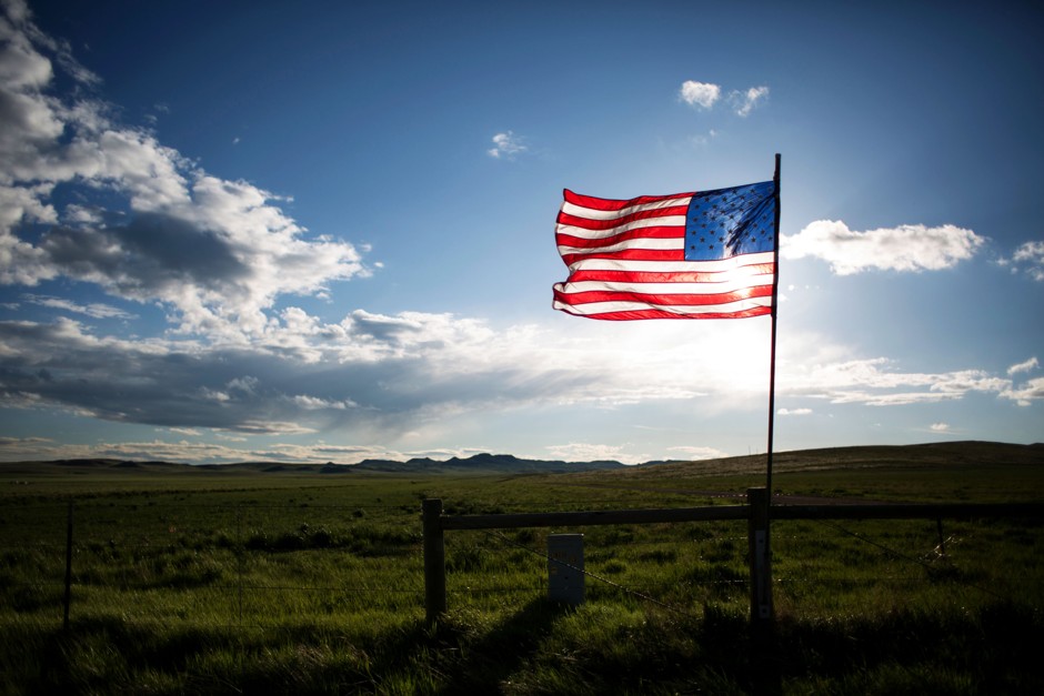 A flag along Wyoming Highway 59 near a housing development. Because each state is allotted two U.S. senators, a resident of Wyoming has 68 times the Senate voting strength of a Californian.