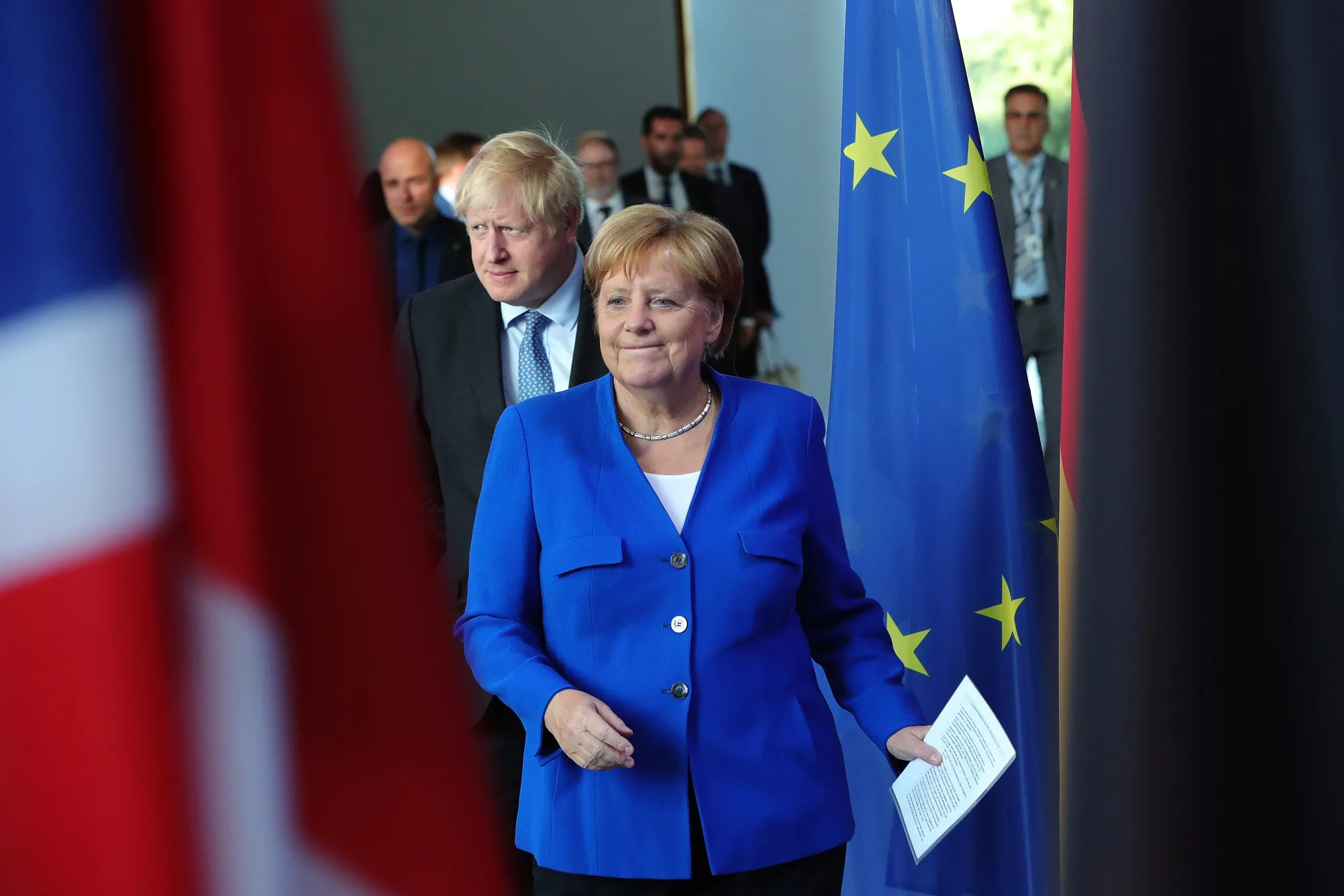 Angela Merkel, Germany's chancellor, right, and Boris Johnson, U.K. prime minister, arrive for a news conference&nbsp;in Berlin on Aug. 21, 2019.