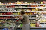 A woman checks the price of an item at a grocery store in Buenos Aires, Argentina.