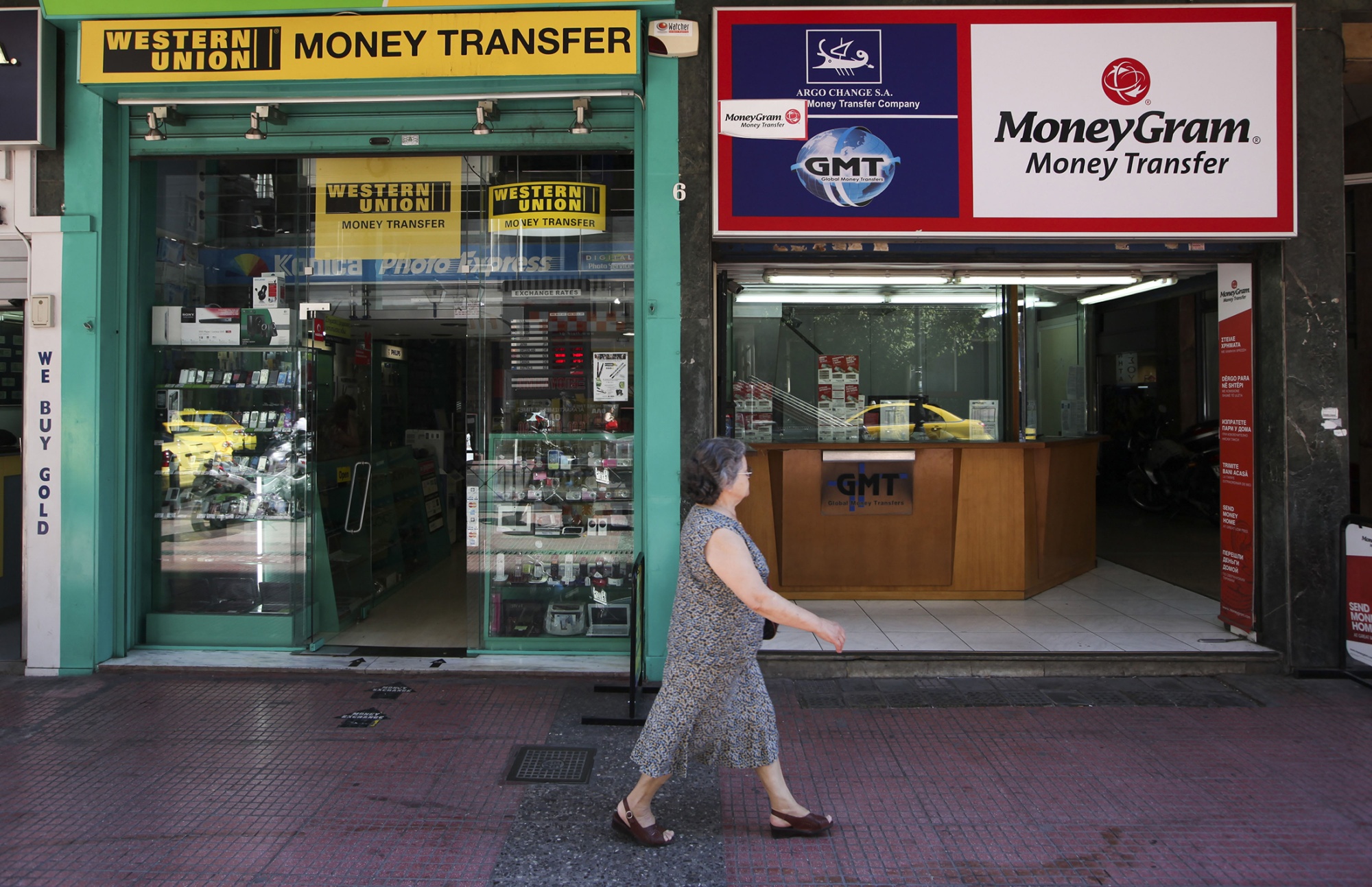 A pedestrian passes Western Union&nbsp;and MoneyGram International stores.