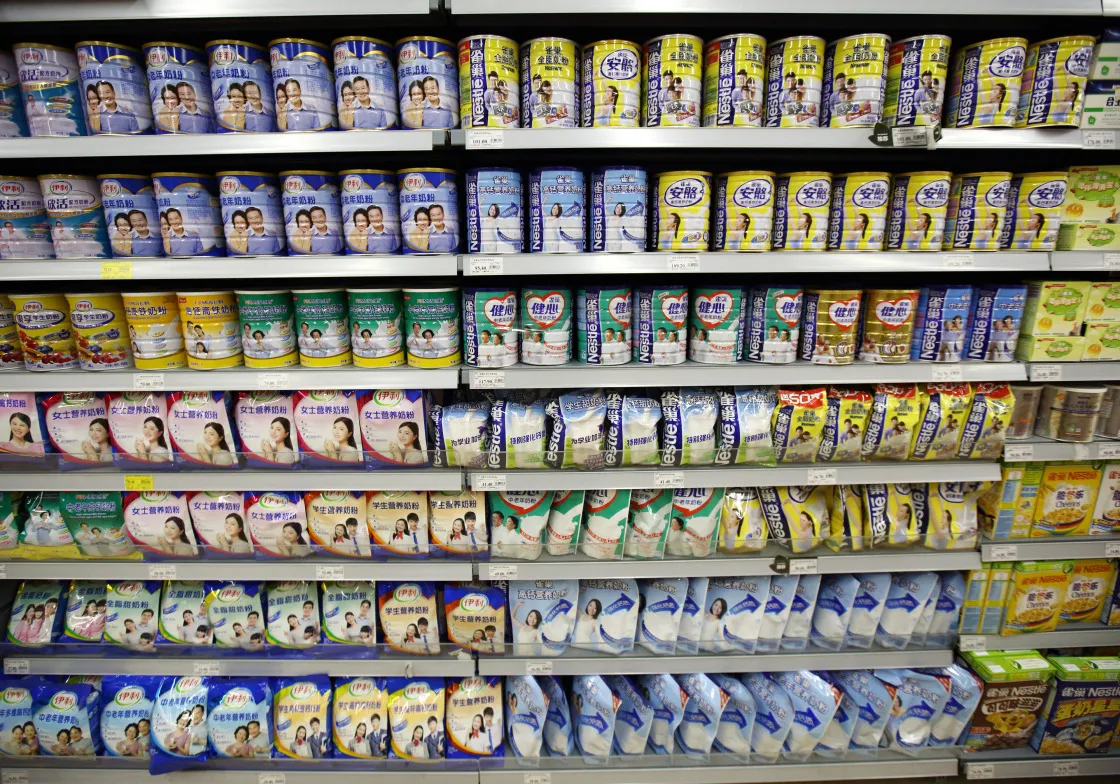 Milk formula products manufactured by Inner Mongolia Yili Industrial Group Co., left, and Nestle SA, right, sit on a shelf inside a supermarket in Beijing, China, on Saturday, March 14, 2015. China is the world's largest dairy importer, accounting for about 30 percent of global purchases, according to Fonterra Cooperative Group Ltd.