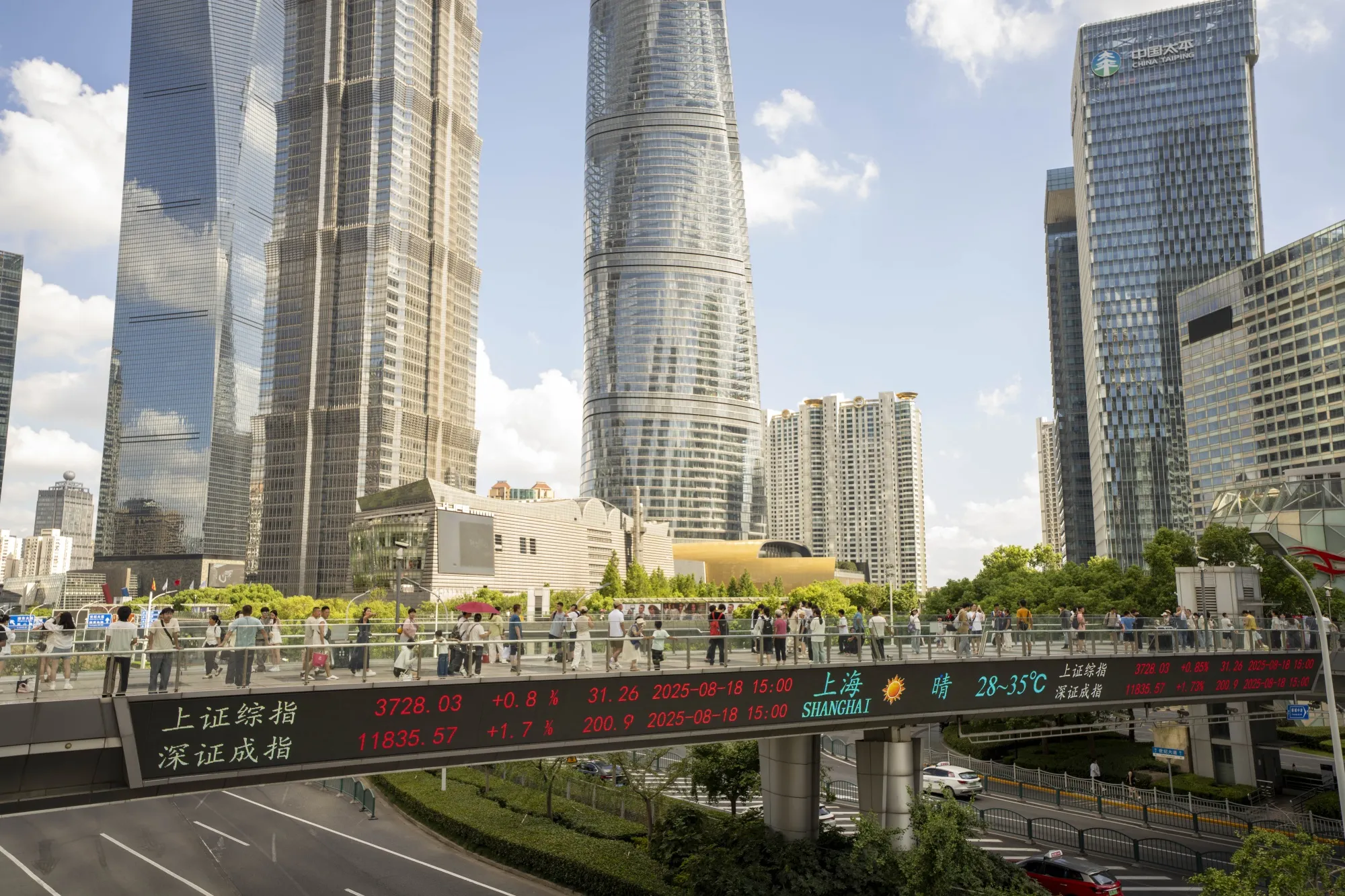 An electronic ticker displays stock figures in Pudong's Lujiazui Financial District in Shanghai, China, on Monday, Aug. 18, 2025. A gauge of Shanghai-listed stocks closed at its highest level in a decade, as cash-rich local investors plow into a market that has surged amid easing trade tensions with the US.