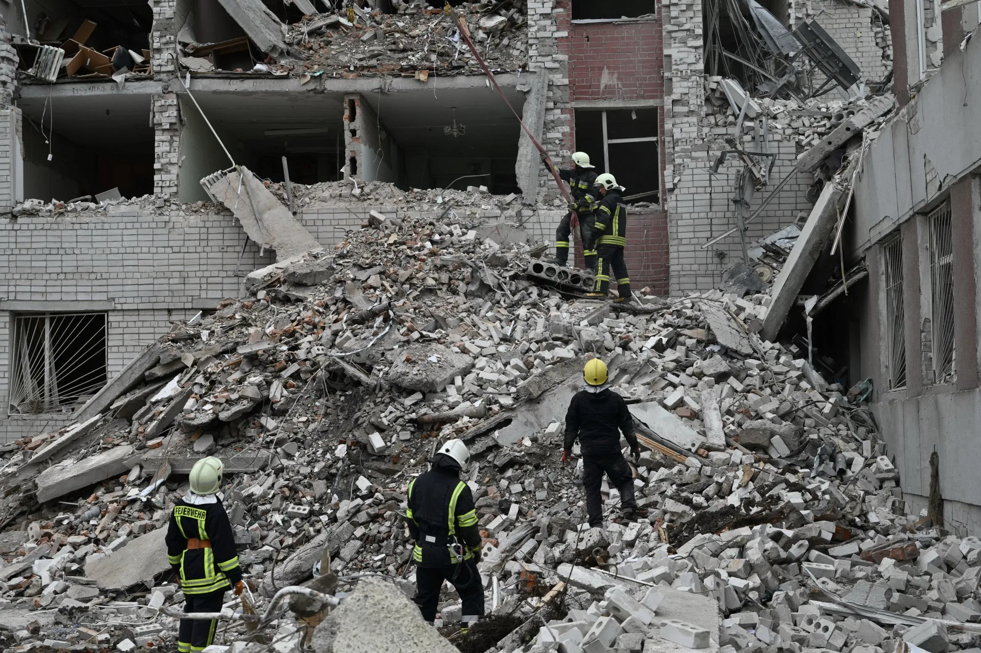 Ukrainian rescuers clear rubble at a destroyed building following a missile attack in Chernihiv on April 17.