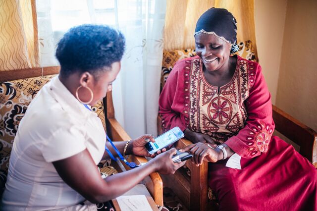 Two community health workers training to use Simprints in Rwibaale, Uganda.