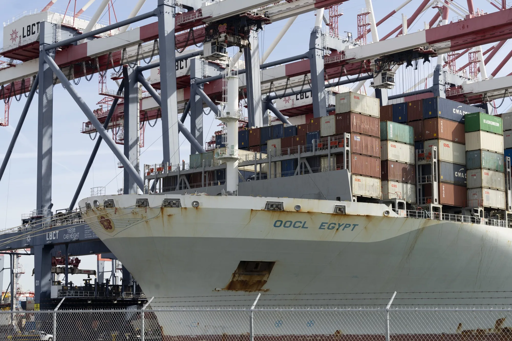 A cargo ship docked at the LBCT container terminal at the Port of Long Beach in Long Beach, California.