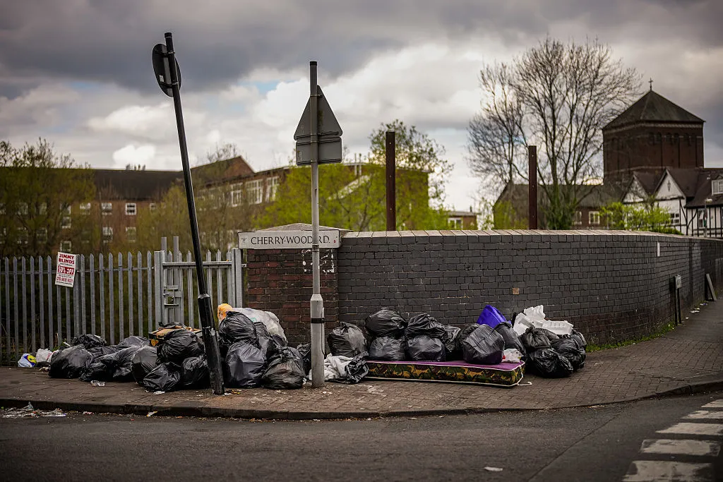 Uncollected household waste and rubbish blights the corner of a street as Birmingham council refuse collectors continue their strike.