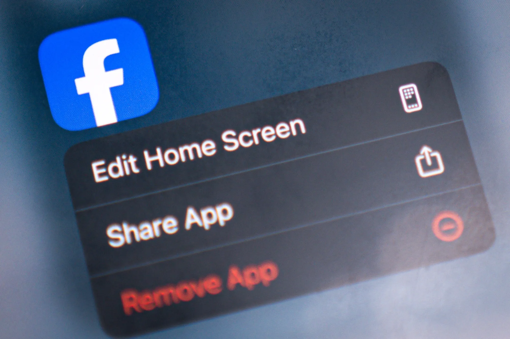 The logo for the Facebook application arranged on a smartphone.
