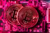 Two coins representing Bitcoin virtual cryptocurrency sit on a computer circuit board in this arranged photograph in London, U.K., on Tuesday, Feb. 6, 2018. Cryptocurrencies tracked by Coinmarketcap.com have lost more than $500 billion of market value since early January as governments clamped down, credit-card issuers halted purchases and investors grew increasingly concerned that last year’s meteoric rise in digital assets was unjustified.