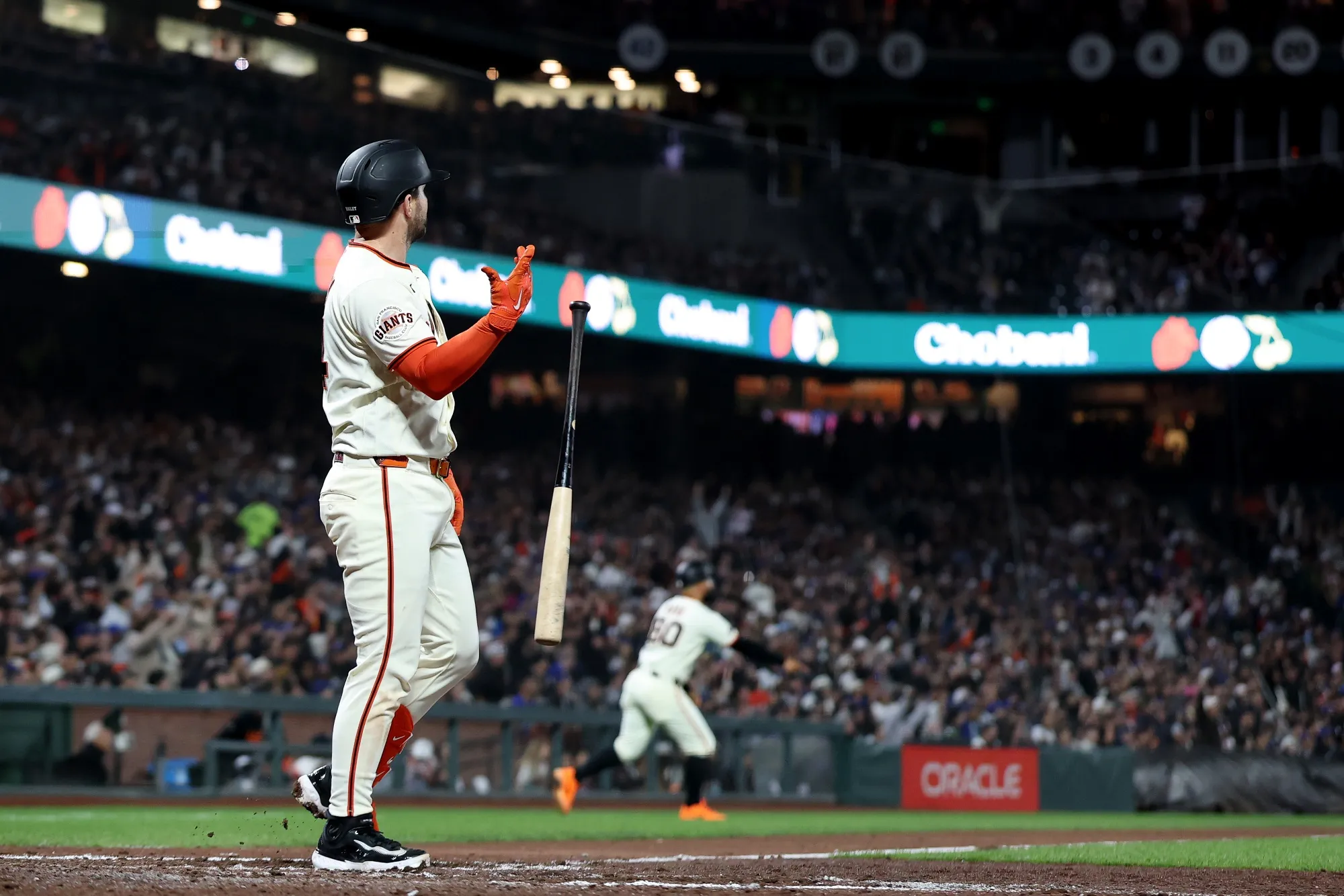 Patrick Bailey of the San Francisco Giants lets go of his bat after he hit a three-run home run at Oracle Park in San Francisco.
