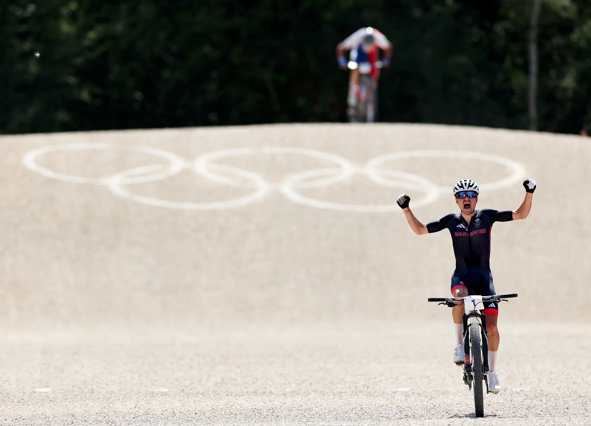 Thomas Pidcock celebrates at finish line as the gold medal winner during the Men's Cross-Country Mountain Bike Cycling at the Olympic Games Paris on July 29.