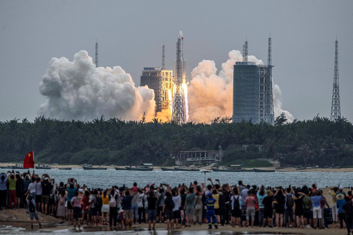 People watch a Long March 5B rocket, carrying China’s Tianhe space station core module, as it lifts off from the Wenchang Space Launch Center in southern China’s Hainan province on April 29.