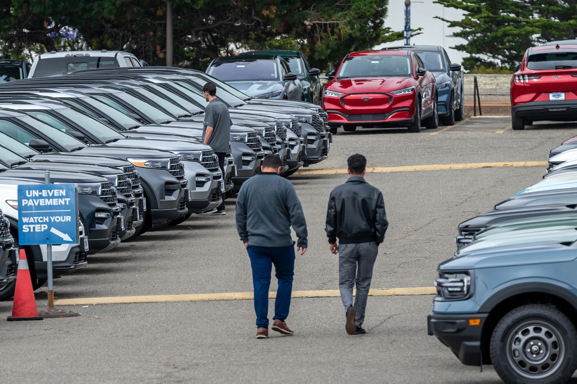 Customers view used Ford vehicles at a dealership in Colma, California.