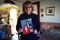 Kathy Kozachenko at home in Pittsburgh, holding a photograph of herself with her partner, MaryAnn Geiger, and their son, Justin.