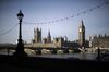 The Big Ben clock tower and the Houses of Parliament, left, stand with Portcullis House, right, beyond the River Thames and Westminster Bridge in London, U.K., on Wednesday, March 5, 2014. U.K. stocks declined, after the FTSE 100 Index posted its biggest rally in eight months, as investors awaited data on jobs and services from the U.S.