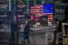 Monitors displaying stock market information are seen through the window of the Nasdaq MarketSite in the Times Square neighborhood of New York, U.S., on Thursday, March 19, 2020. New York state Governor Andrew Cuomo on Thursday ordered businesses to keep 75% of their workforce home as the number of coronavirus cases rises rapidly.