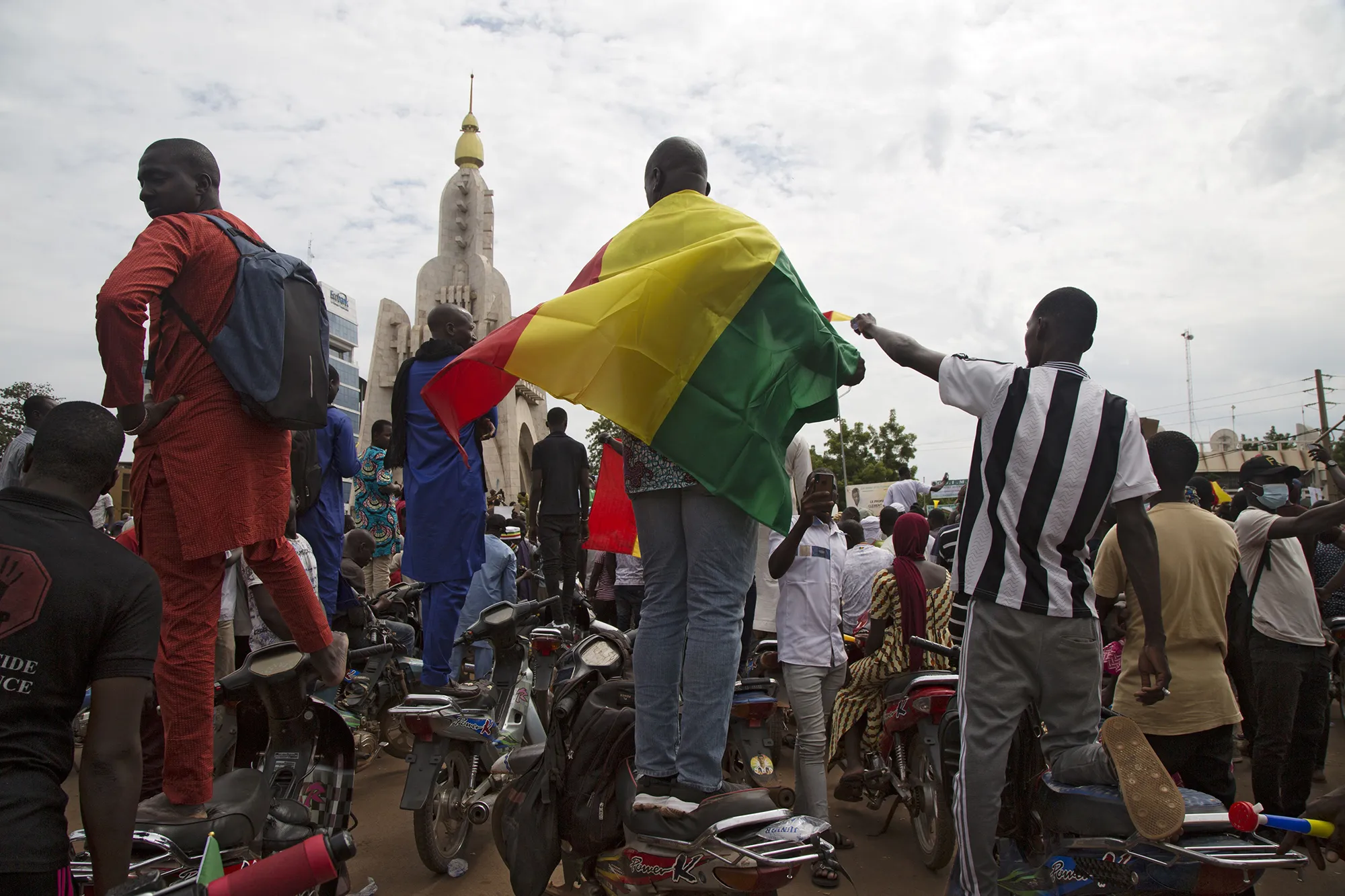 A man wears a Mali national flag as demonstrators gather in&nbsp;Independence square in Bamako, on Aug.&nbsp;21.