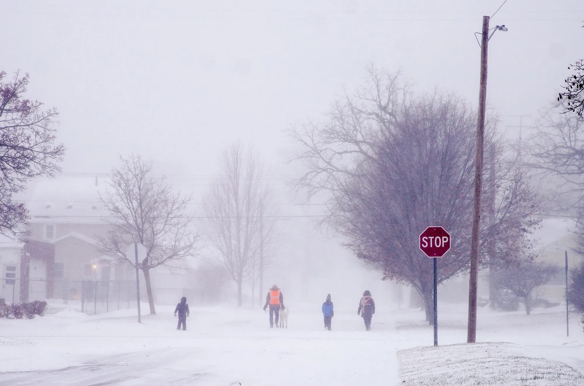 A family walks through the storm in Flint, Michigan on Dec. 23.