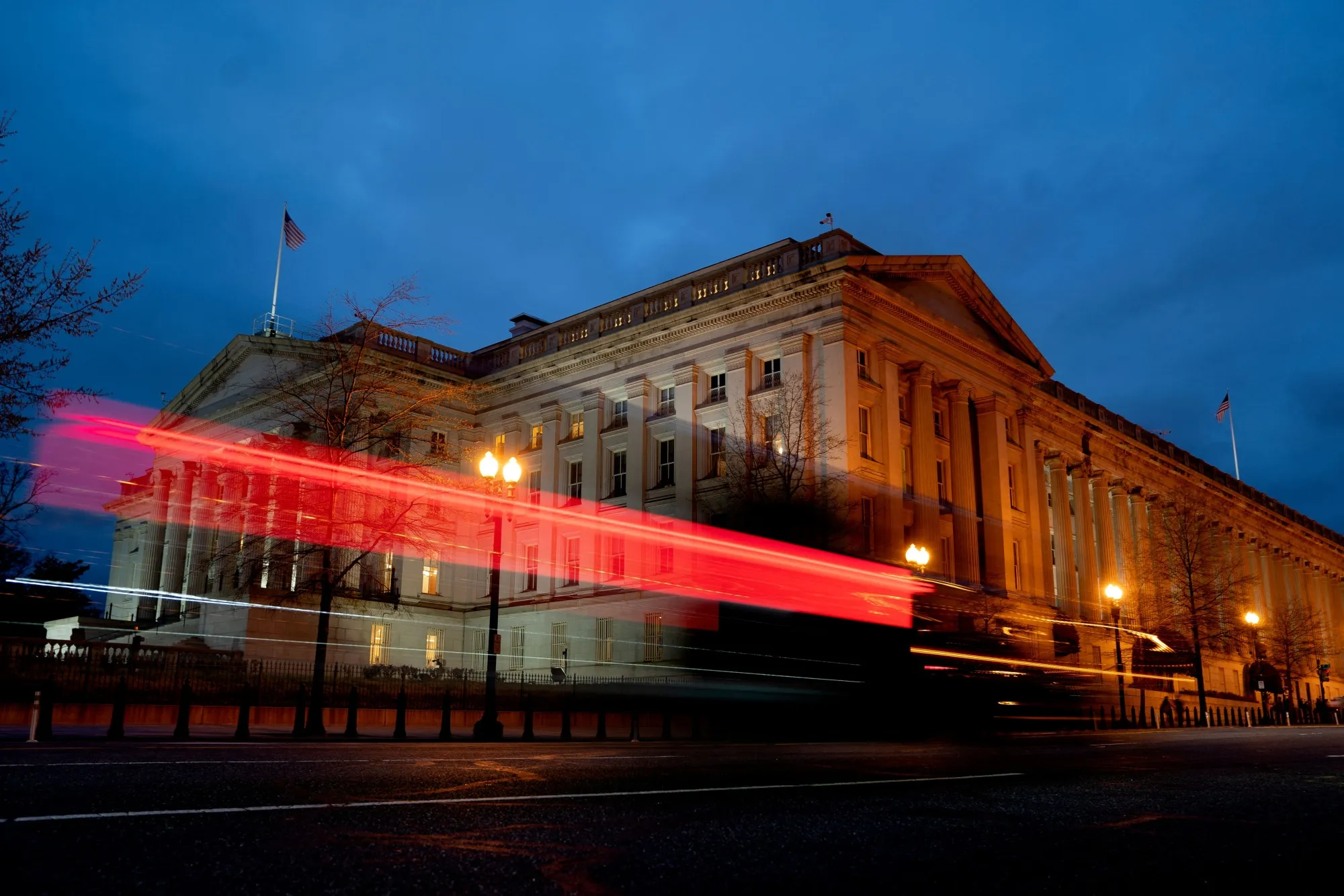 A vehicle drives past the US Treasury Department in Washington, DC.&nbsp;