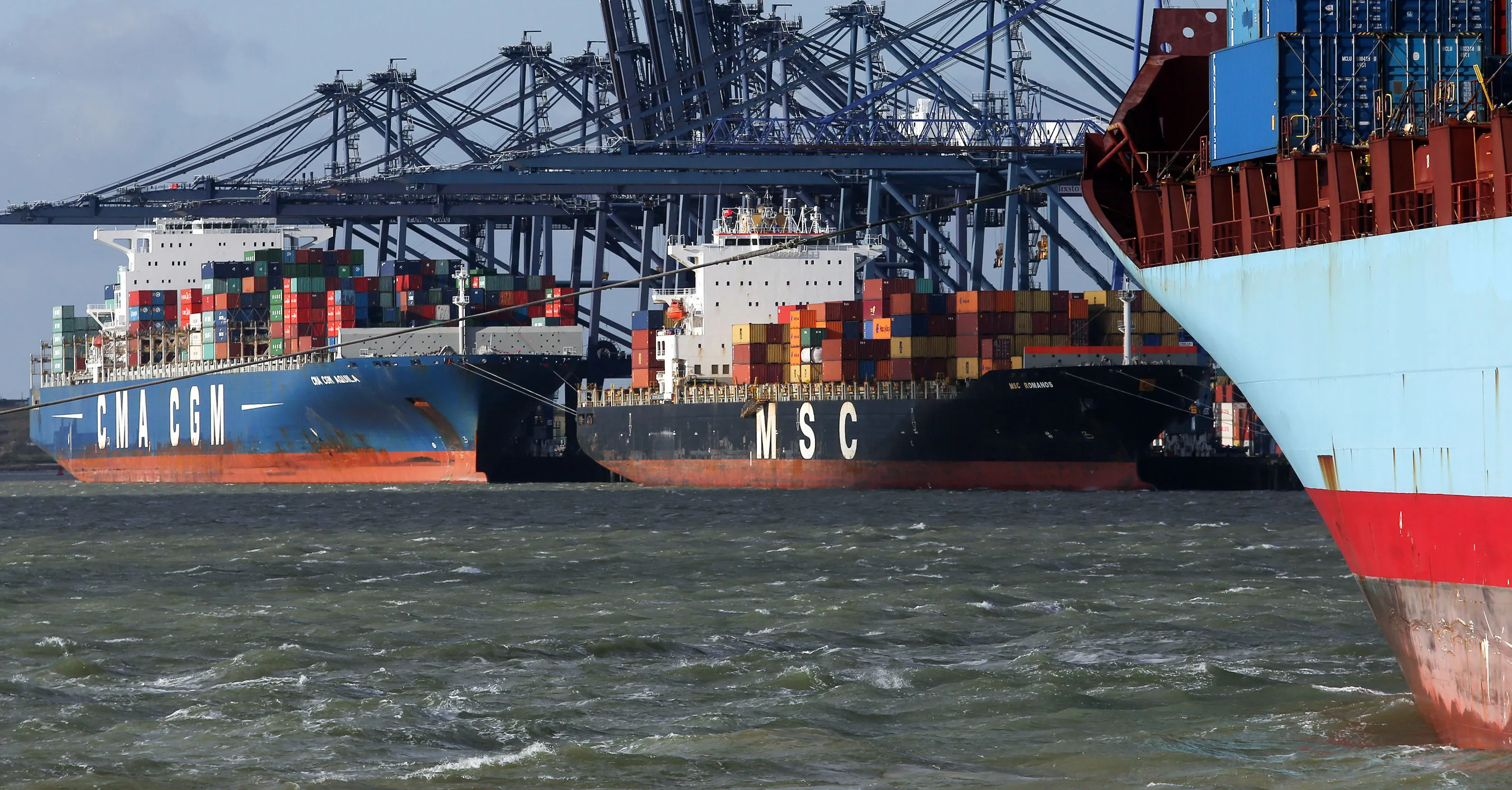 The CMA CGM Aquila, left, and the Mediterranean Shipping Co. (MSC) Romanos, centre, sit dockside at the Port of Felixstowe Ltd., a subsidiary of CK Hutchison Holdings Ltd., in Felixstowe, U.K.
