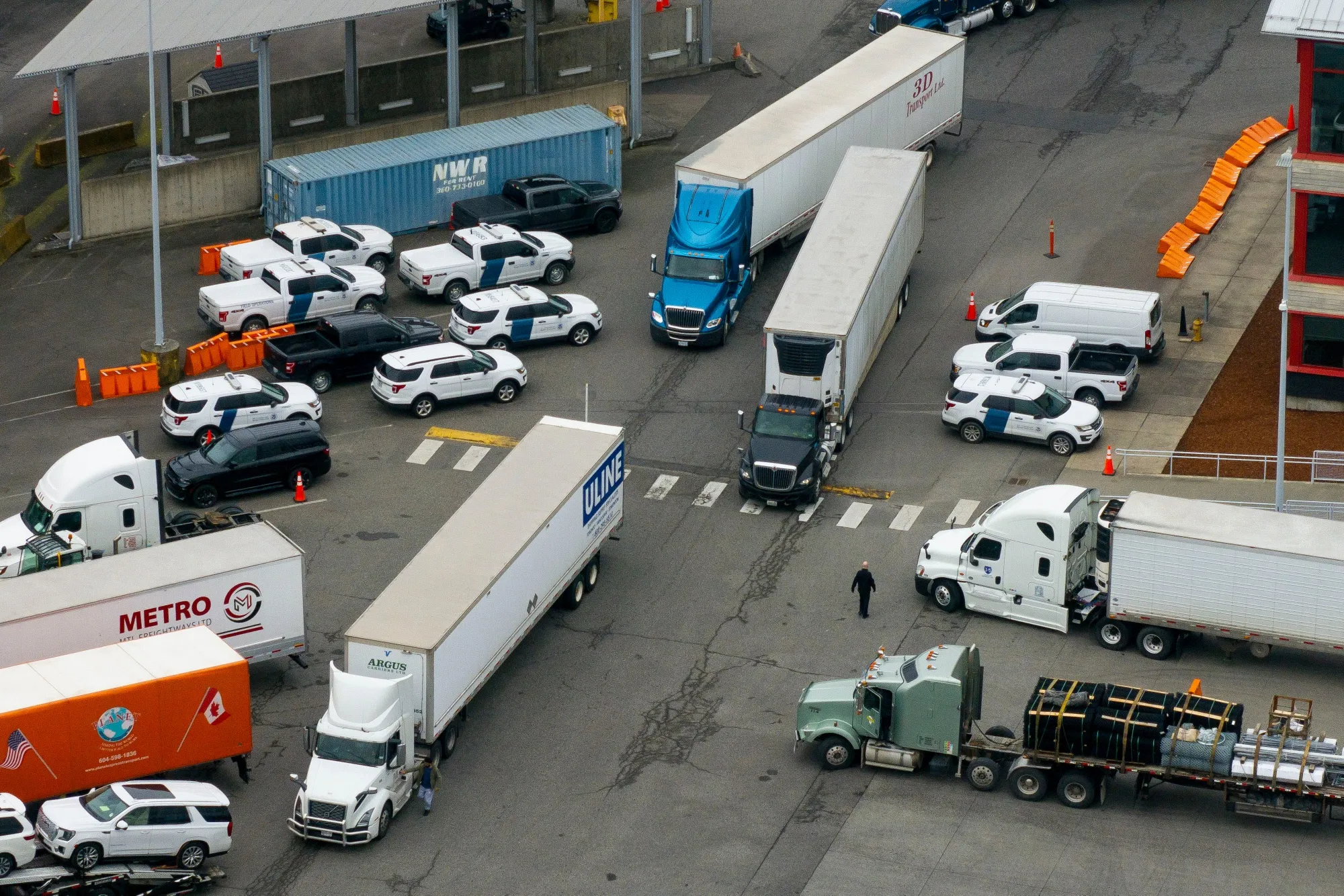 Tractor trailers entering the US from Canada at the Pacific Highway Border Crossing in Blaine, Washington, on March 3.