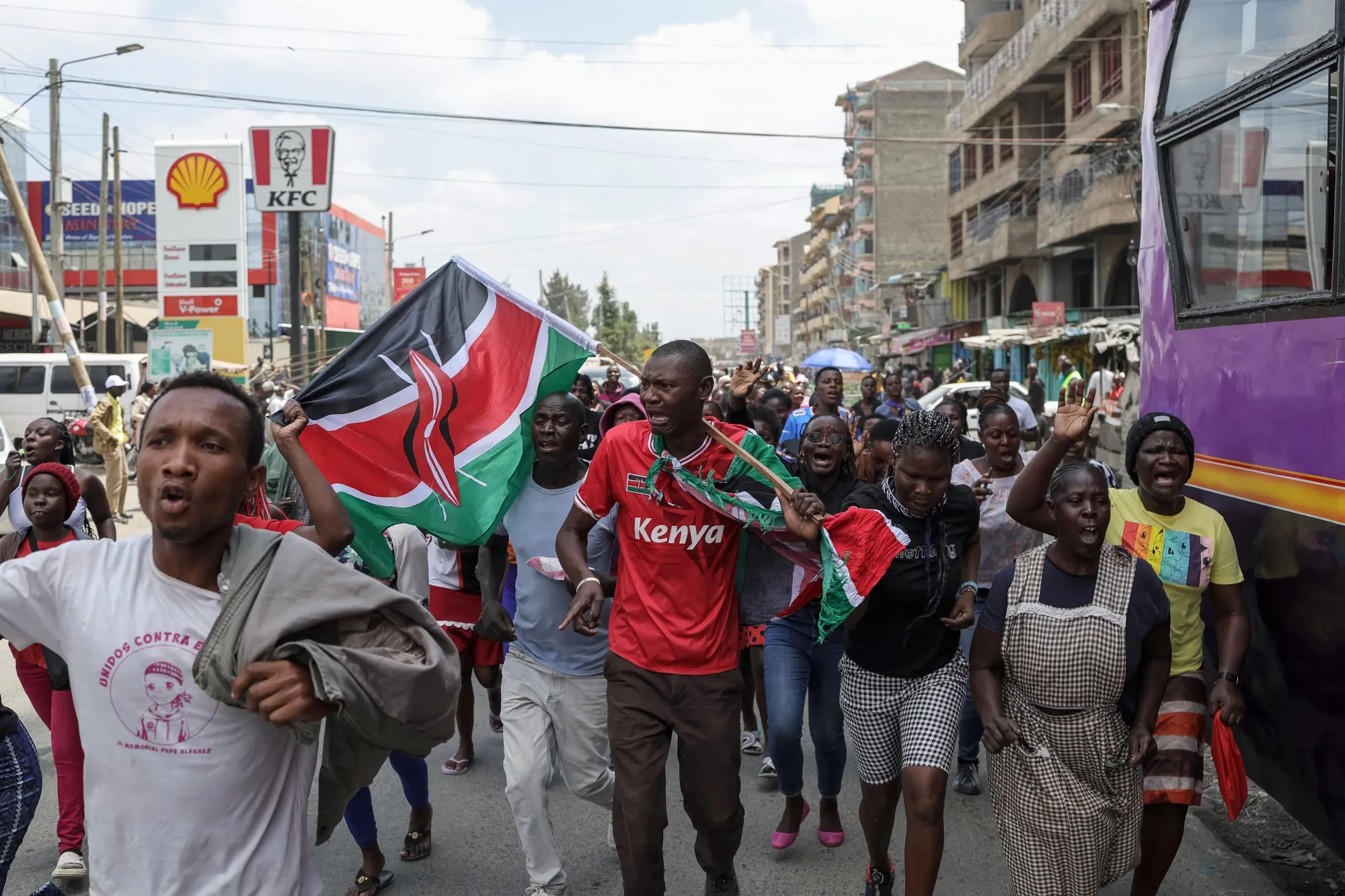 Mourners carry Kenyan flags following the death of Raila Odinga, in Nairobi on Oct. 15.