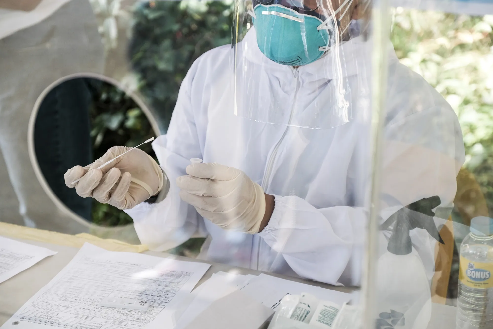 A healthcare worker collects samples for a Covid-19 antigen test in Quezon City, the Philippines, on Jan. 6.