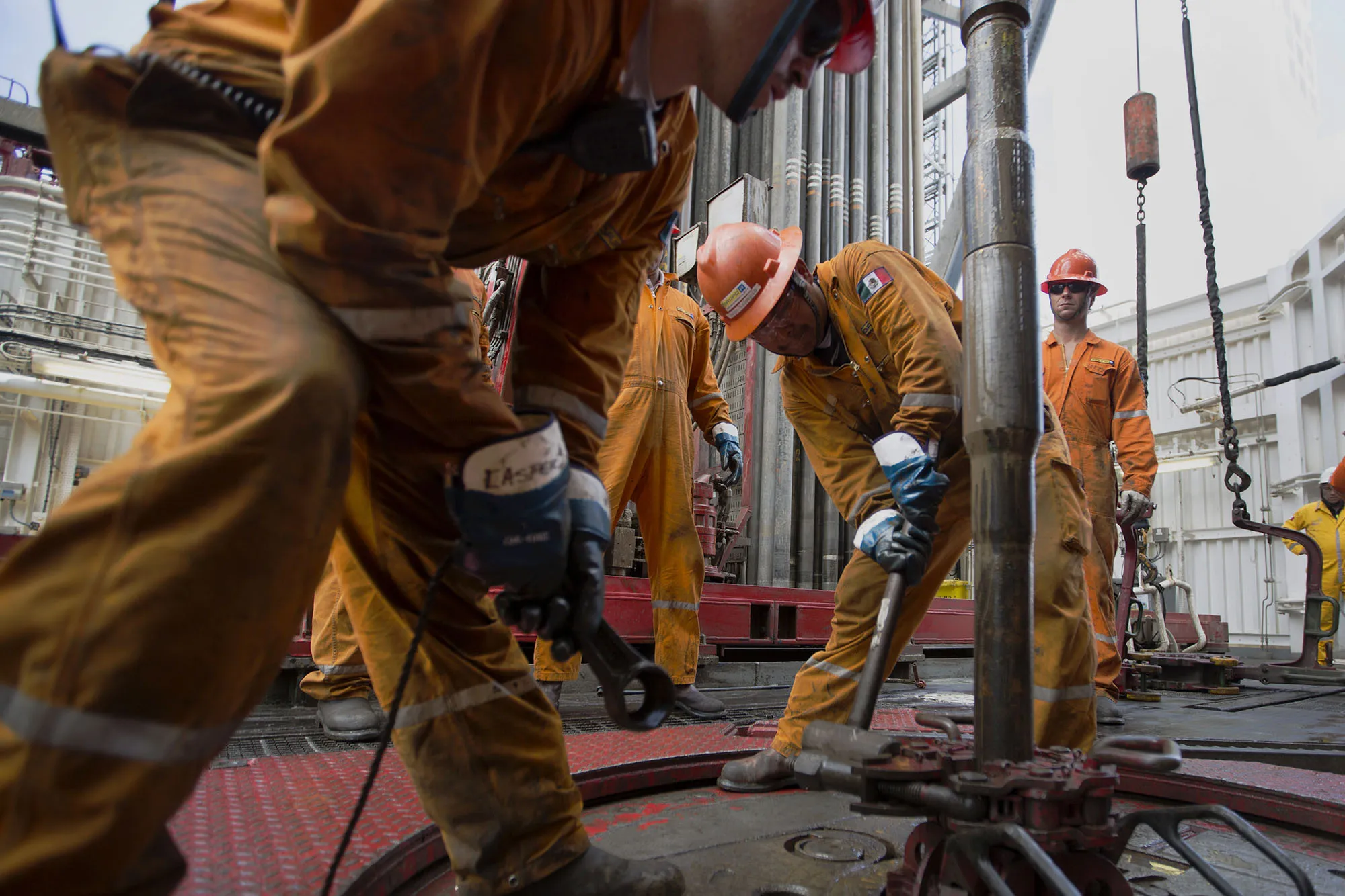 Workers prepare drilling pipe on a deep sea crude oil platform in the waters off Veracruz, Mexico.
