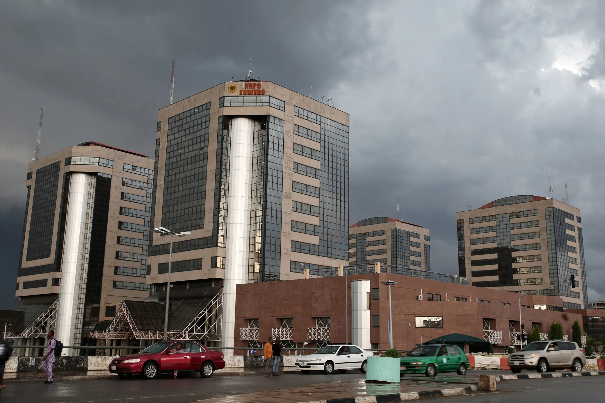 Traffic passes the head offices of the Nigerian National Petroleum Corp. in Abuja.