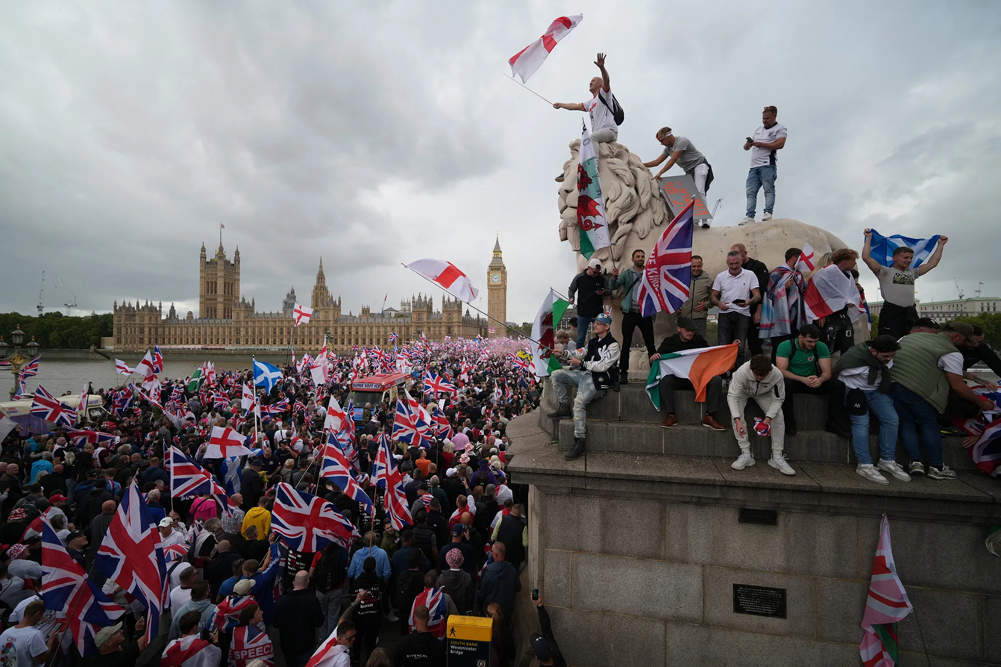 Protesters wave flags during the "Unite The Kingdom" rally on Westminster Bride in London on Sept. 13.