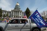 To protest Colorado's stay-at-home orders, conservative groups organized a drive-through rally at the state capitol in Denver on April 19.