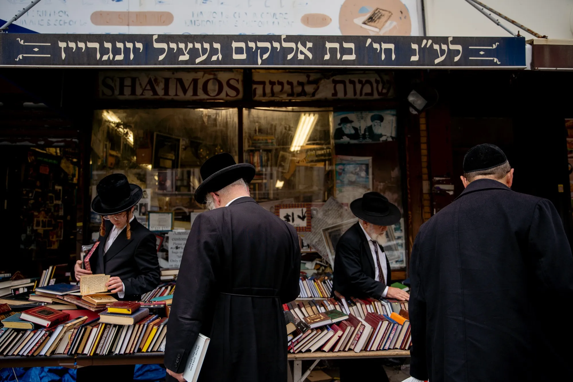 Customers view books displayed for sale outside a bookstore in the Borough Park neighborhood in the Brooklyn borough of New York, U.S., on&nbsp;Sept. 24.