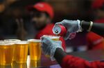 Staff member pours a beer at a fan zone ahead of the FIFA World Cup, in Doha, Qatar Saturday, Nov. 19, 2022. The last-minute decision to ban the sale of beer at World Cup stadiums in Qatar is the latest example of some the tensions that have played out ahead of the tournament. Qatari officials have for long said they were eager to welcome everybody but that visitors should also respect their culture and traditions. (AP Photo/Petr Josek)