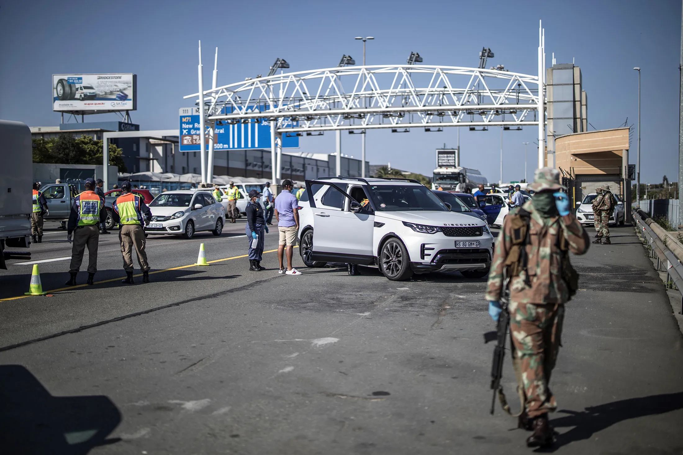 South Africa soldiers are seen at a checkpoint managed by the South Africa Police Services on the N1 highway in Johannesburg, on April 24.