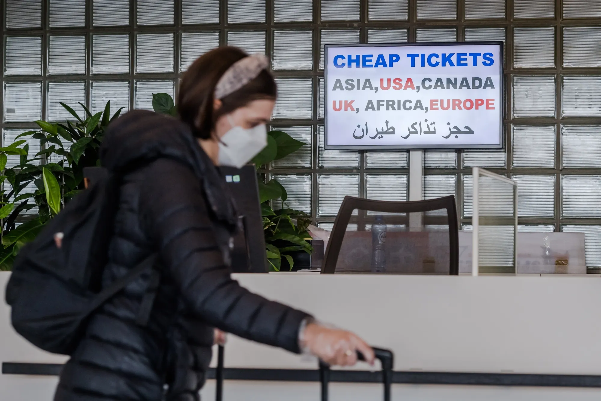 A sign advertising cheap tickets stands behind a passing at Schiphol Airport&nbsp;in Amsterdam, March. 14.&nbsp;