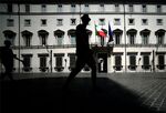 A man walks past the Palazzo Chigi in Rome. 