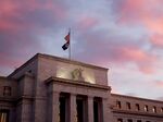 A U.S. flag flies on top of the Marriner S. Eccles Federal Reserve building at sunrise in Washington, D.C.